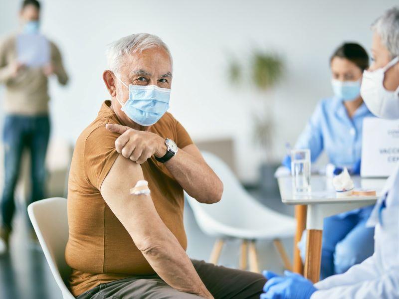 Image of an elderly men receiving a vaccine