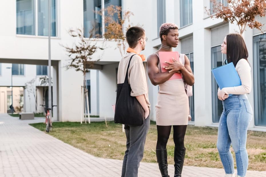 Three diverse students talking on a university campus