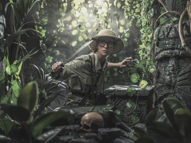 young woman in pith helmet exploring the jungle