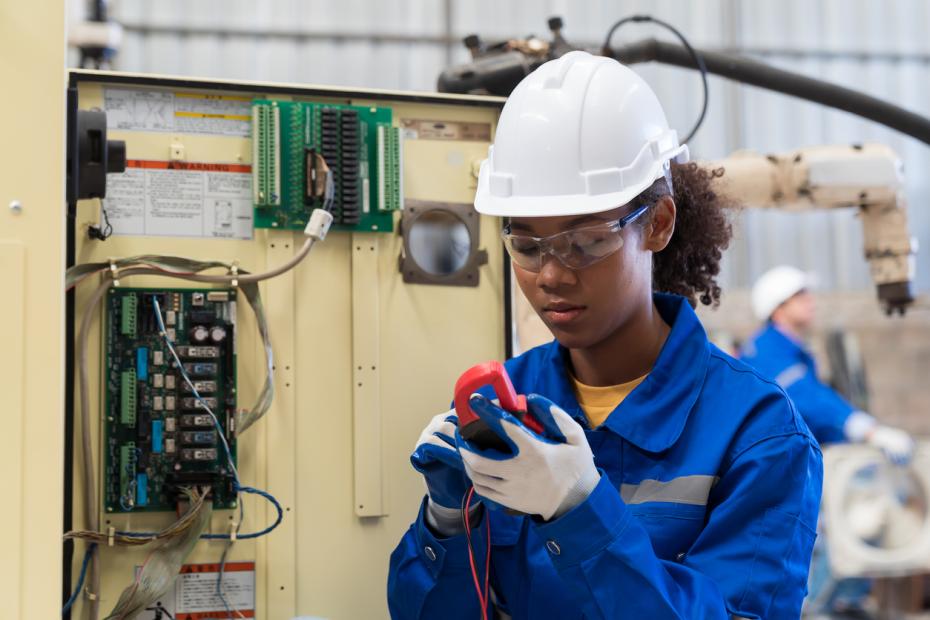 Young woman working as an electrician