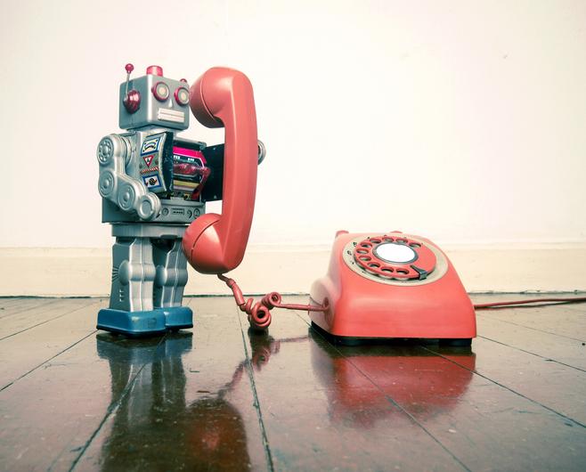 A toy robot answers a toy phone