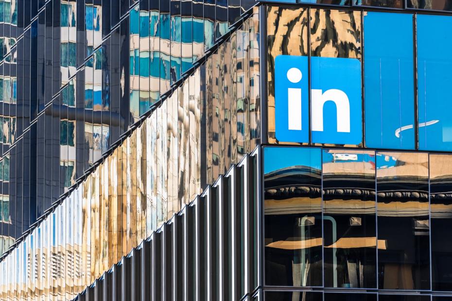 LinkedIn logo reflection against a glass building