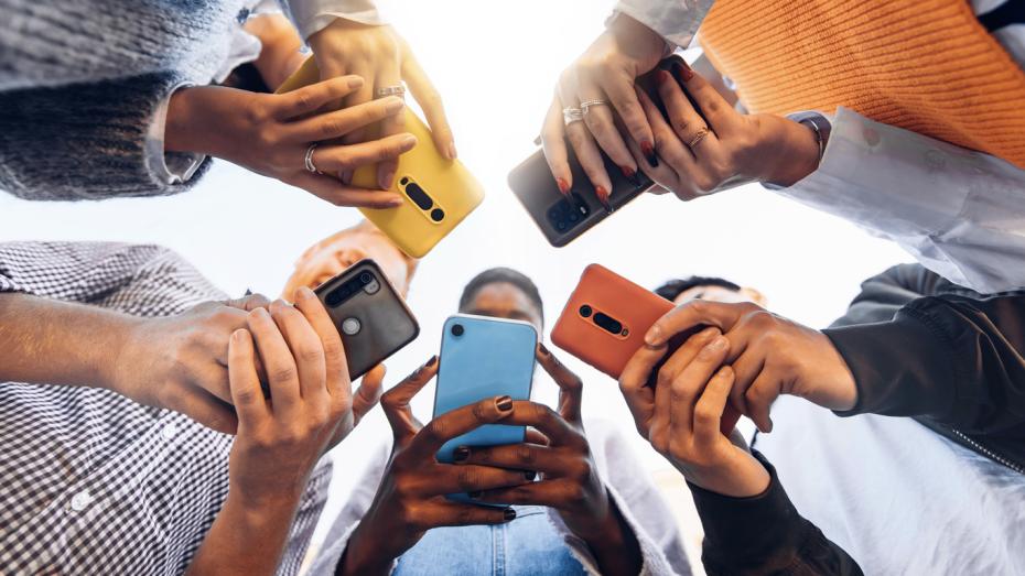 A group of people using their phones for social media