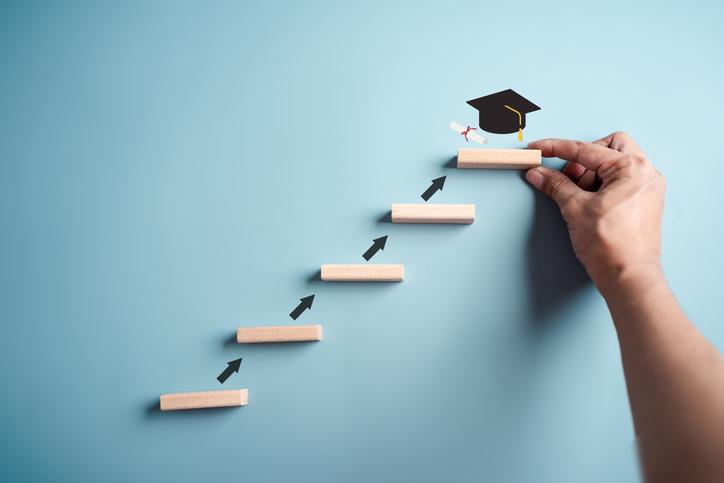 A series of blocks represents an upwards trajectory towards a mortarboard