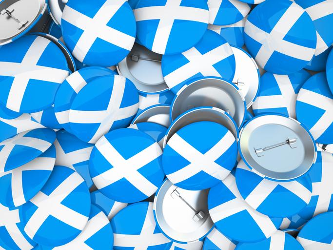Button badges with the Scottish saltire pile up