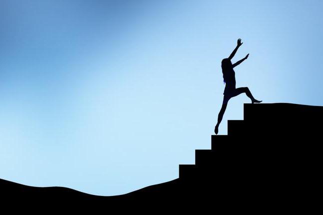 silhouette of woman climbing stairs