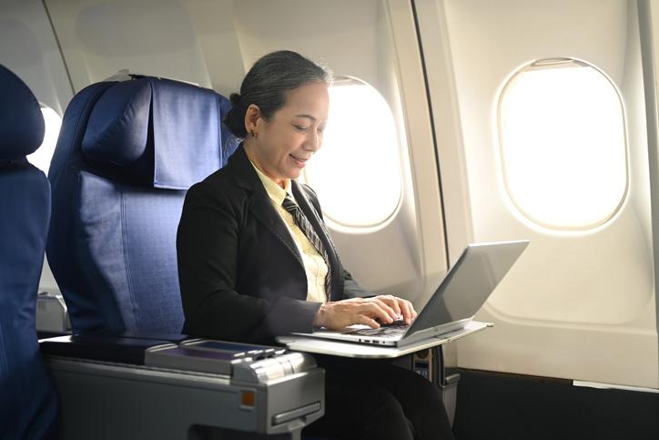 Asian woman working on plane