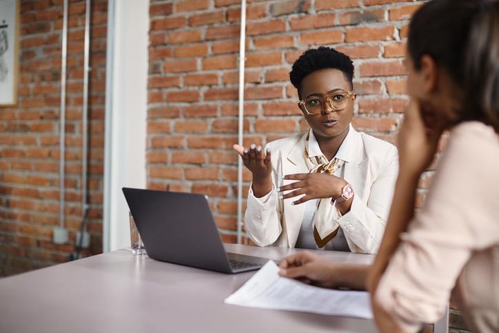 Black woman mentoring younger colleague