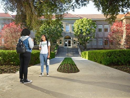 Students standing outside of a campus building at the University of La Verne