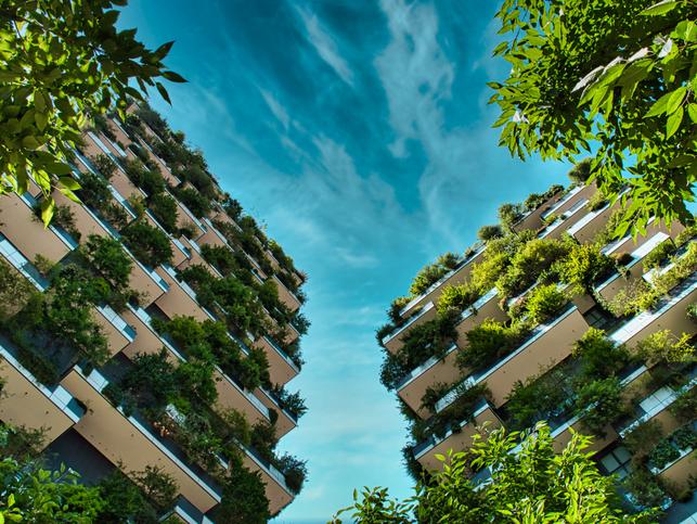 Two skyscrapers covered in plants