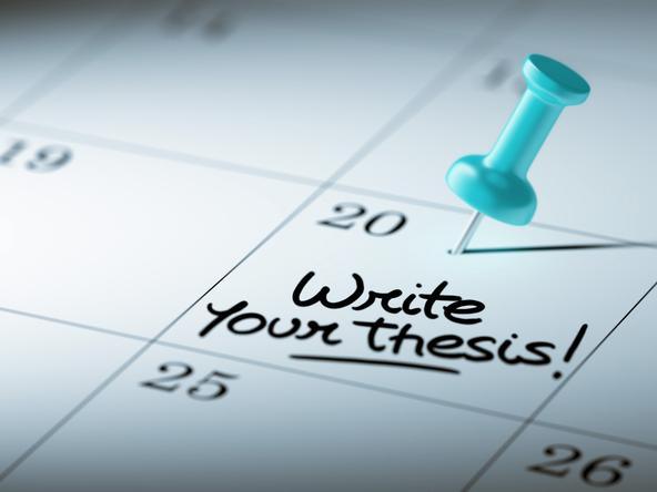 A pin stuck in a calendar on a date that reads: "Write your thesis!"