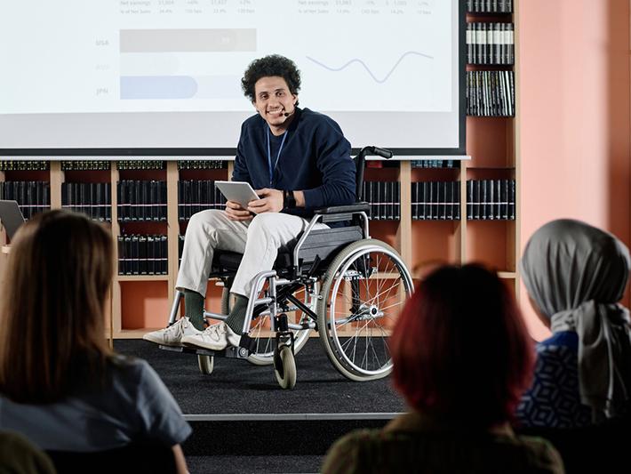 Man in wheelchair giving presentation