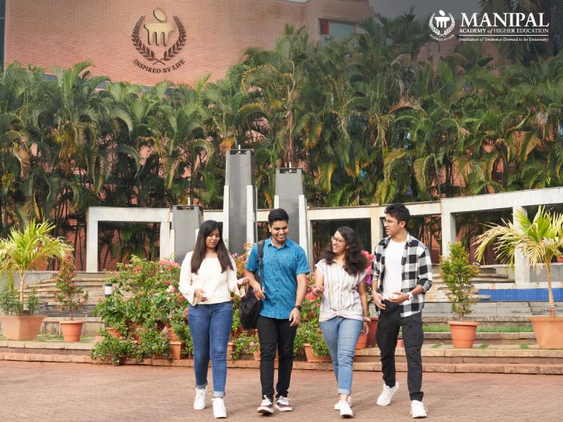 Manipal campus building with students walking outside it