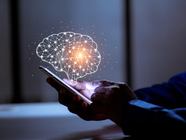 A holographic image of a brain emerges from a smartphone