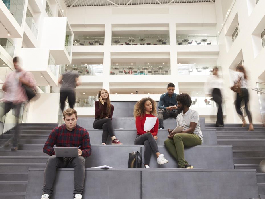 Students sitting on the stairs of a university campus building