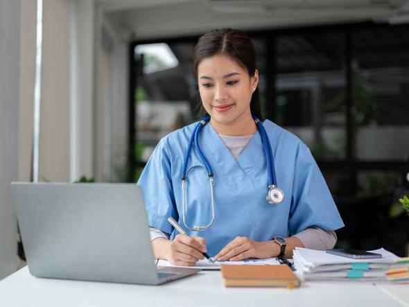 A medical student works from her laptop