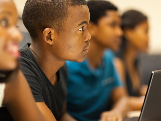 A Black student in a lecture hall