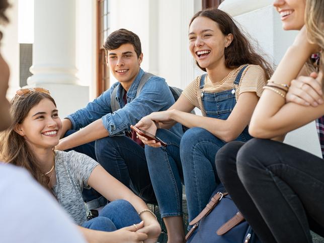 A group of students laugh together