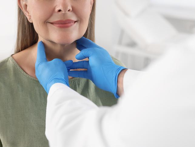 A health professional checks a patient's lymph glands