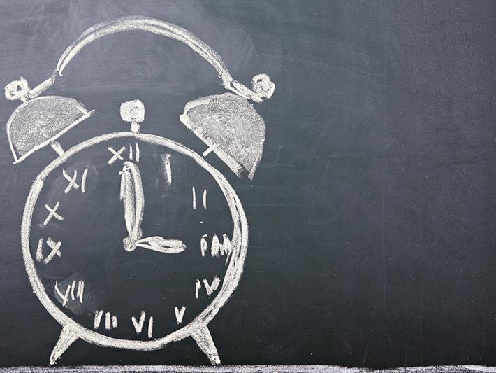 Clock drawn on blackboard, time management