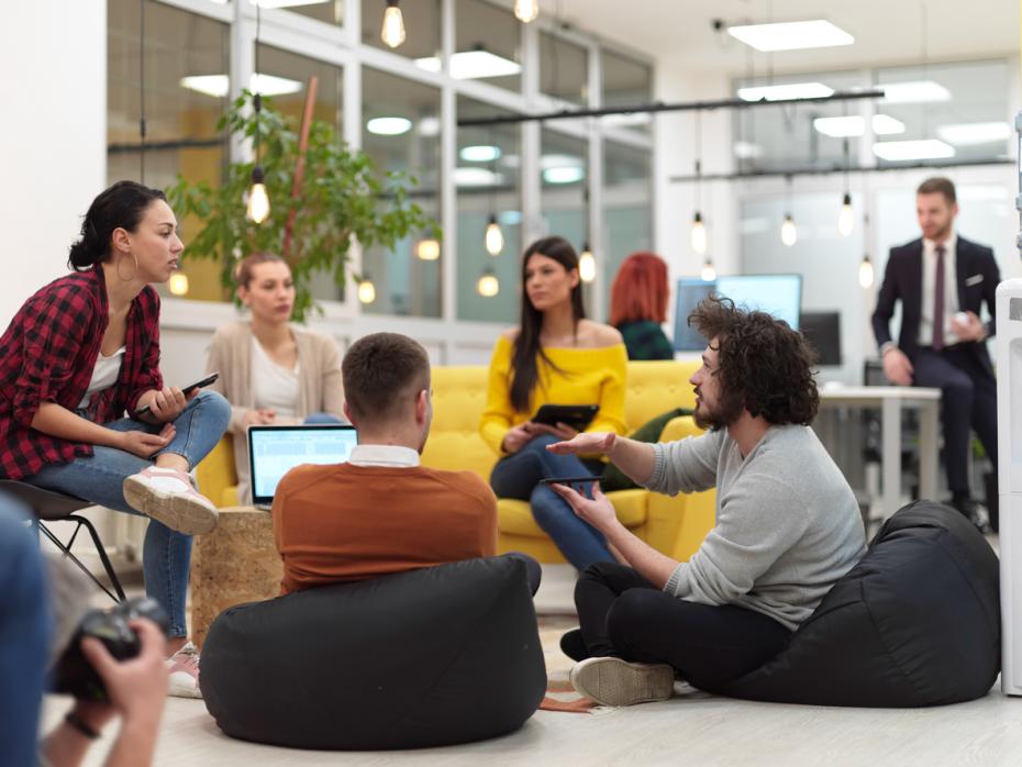 A group of business students brainstorming on bean bags