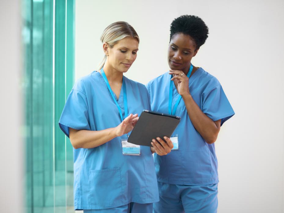 Healthcare workers looking at a tablet