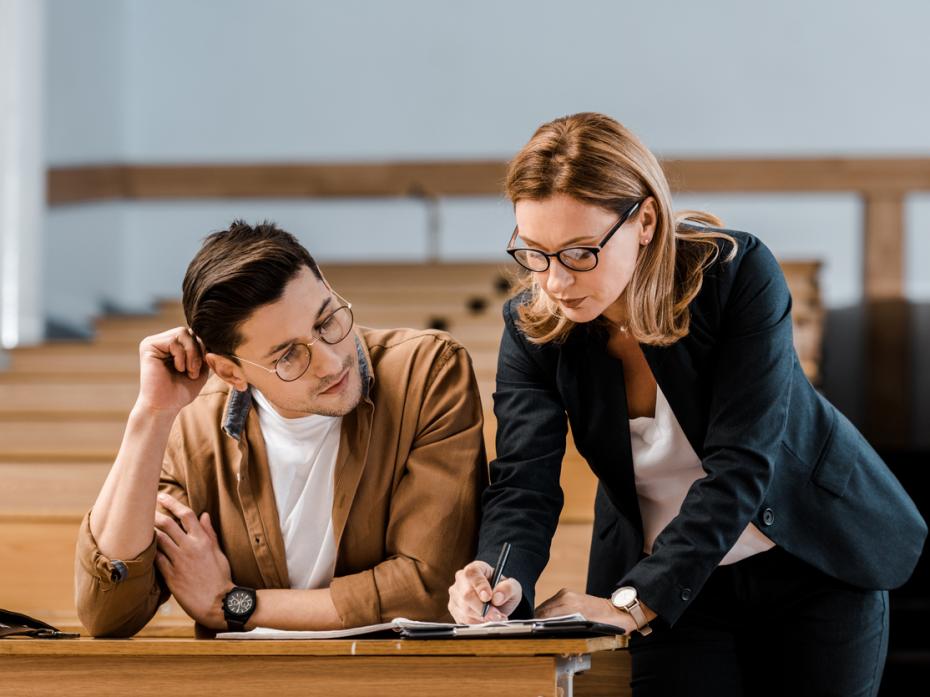 A teacher giving a student feedback 