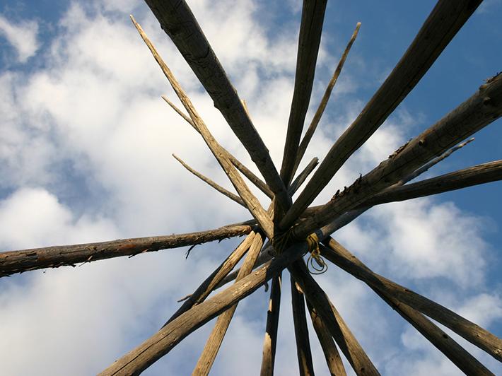 Structure of teepee against blue cloudy sky