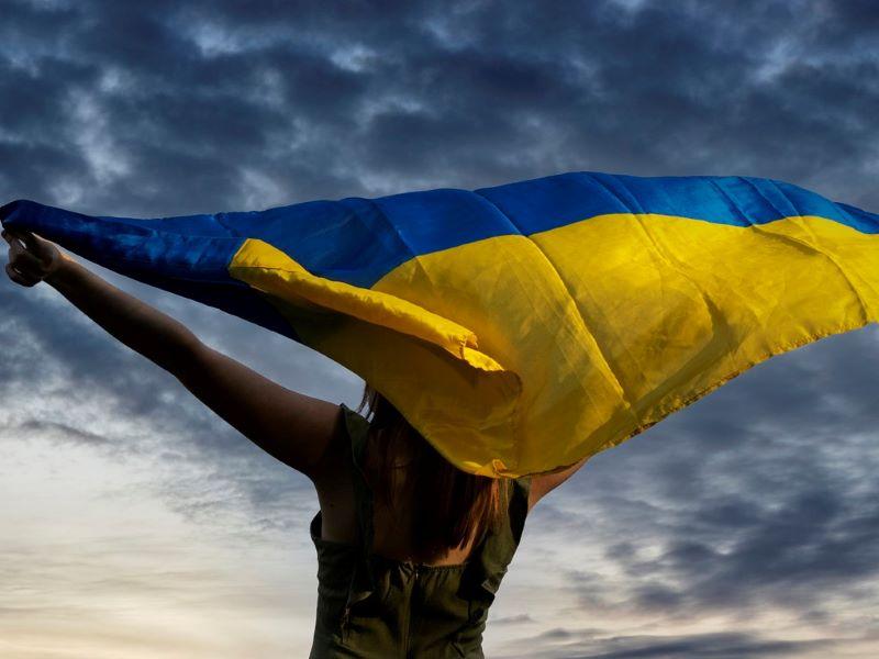 A woman waving the Ukrainian flag 