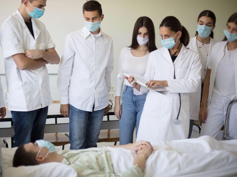 Image of medical students being taught using a mannequin patient