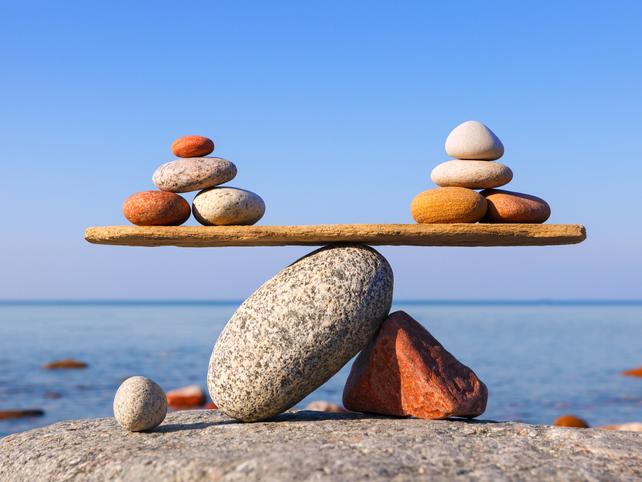 Balancing stones on beach