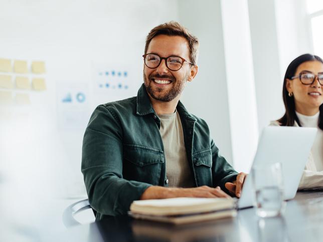 smiling young male employee in meeting