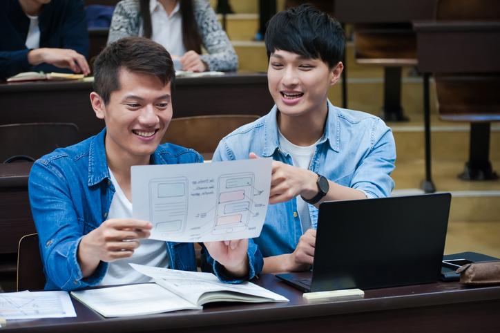 Two male Asian students in a lecture theatre