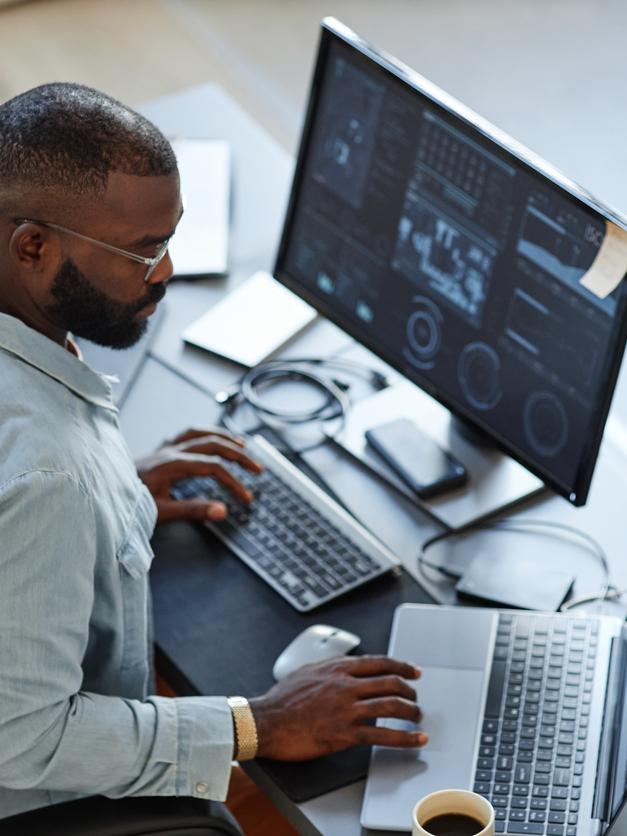 A young man at a computer analysing data