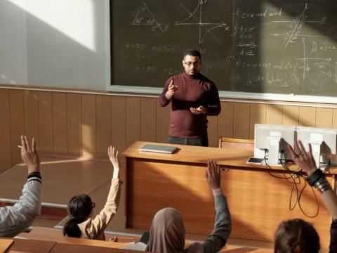 A lecturer taking questions from his students
