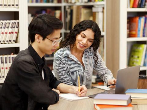 Two tutors discussing marks on a paper