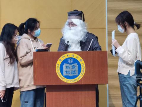 Macau University of Science and Technology students (one wearing a fake beard) in an e-commerce exercise
