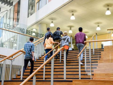 Students walking up stairs on campus