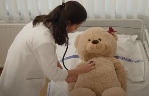 Medical student doing simulated examination on plush bear