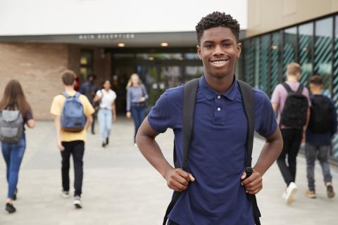 Student standing outside a campus building 