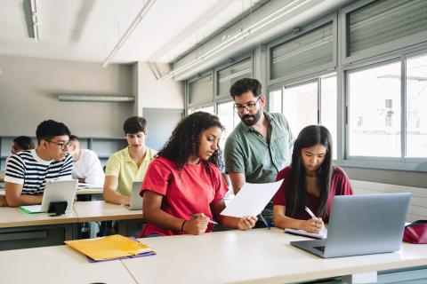 Students in a classroom on their laptops 