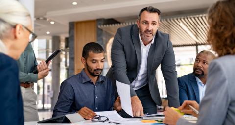 Colleagues debate over an office table