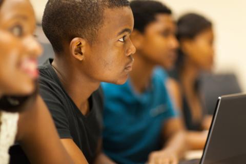 A Black student in a lecture hall