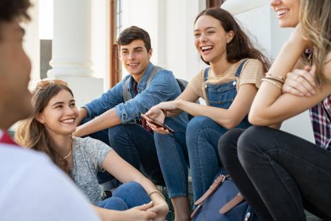 A group of students laugh together