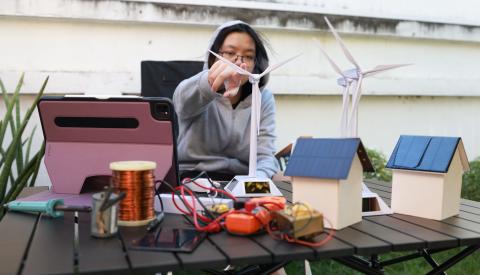 Student testing out a wind turbine model 