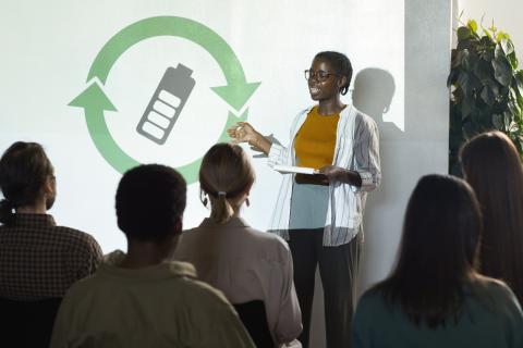 A student presenting a green initiative in front of an audience