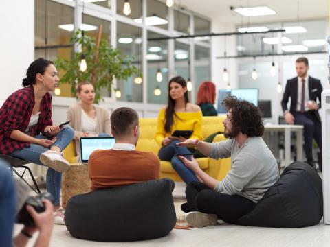 A group of business students brainstorming on bean bags