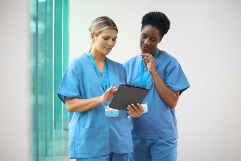 Healthcare workers looking at a tablet