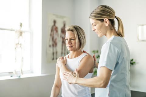 Physical therapist treating patient