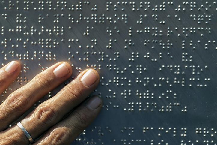 hand reading braille